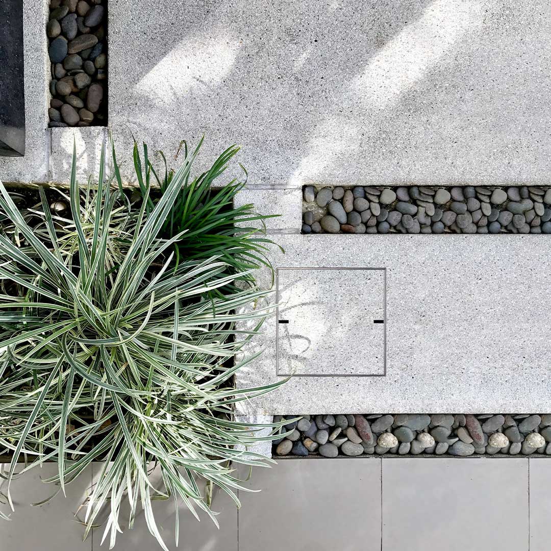 Concrete-inlay HIDE Access Cover, concealed service access in hardscape walkways.