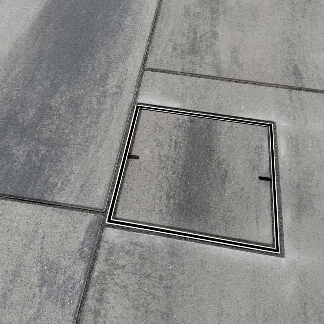 HIDE Drain Cover with dark grey paving inlay.