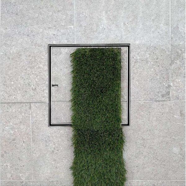 HIDE Drain Cover with artificial turf and grey tile inlay.