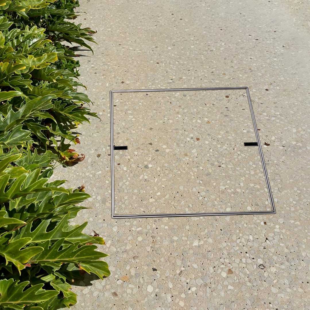 HIDE Concrete Access Cover with exposed aggregate inlay.