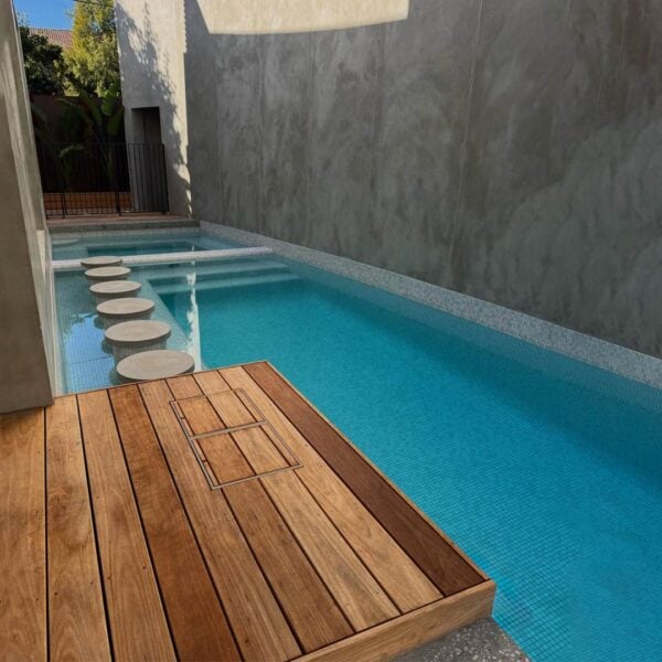 Two HIDE Skimmer Covers with timber decking next to a modern pool.
