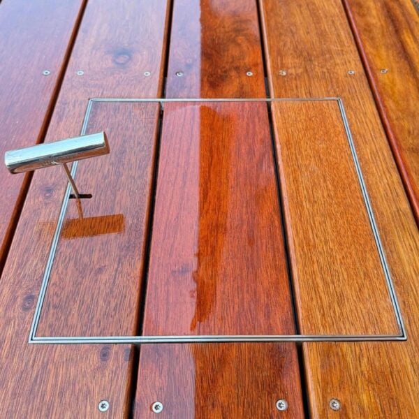 HIDE Access Cover with orange timber decking inlayed to create a seamless transition between surrounding decking and HIDE Lid.