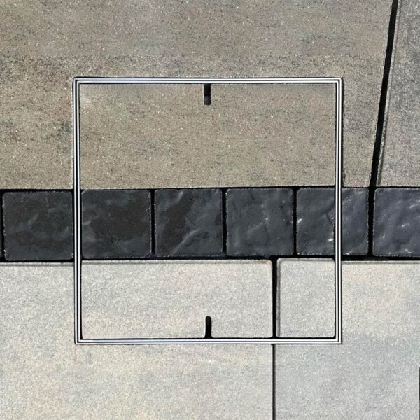 HIDE stainless steel Skimmer Cover set flush with three colour pattern paver inlay; pattern lines continue through the cover to maintain the surrounding paving layout.