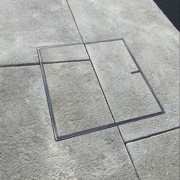 HIDE Skimmer Lid with paving inlay; paving pattern running through the HIDE Cover to create seamless finish.