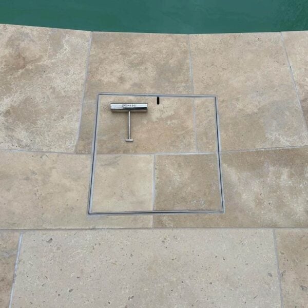 HIDE Stainless Steel Skimmer Cover installed with flush fitting cream tile to create seamless pool hardscape.