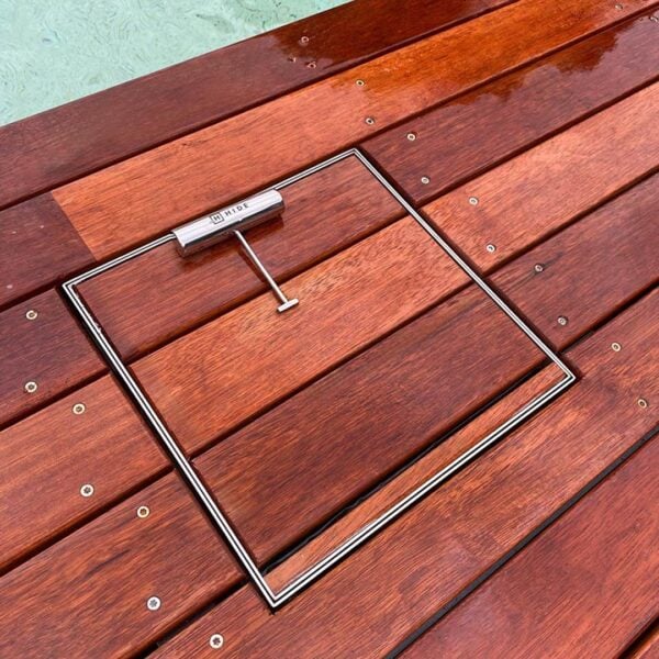 HIDE stainless steel Skimmer Cover shown with timber deck board inlay; board joints continue through the cover, shown with safety key.