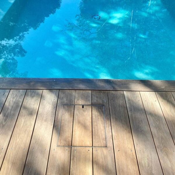 HIDE Skimmer Cover with timber decking inlay installed next to pool.
