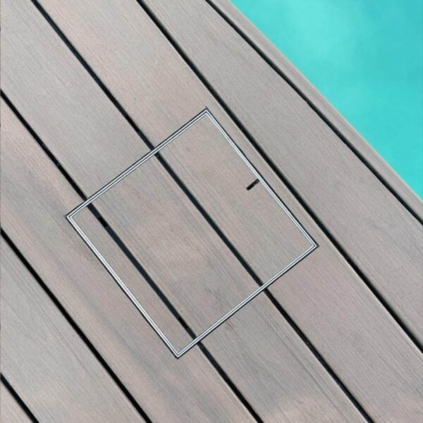 HIDE Stainless Steel Skimmer Cover with composite decking inlay installed next to pool.