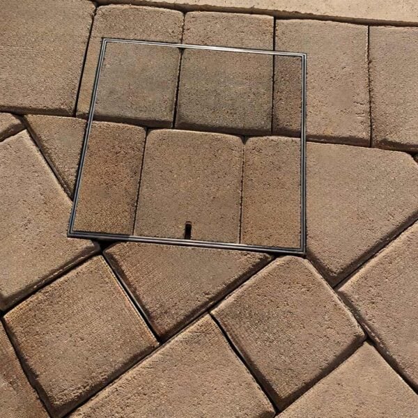 Stainless steel small HIDE Access Cover with orange brick paving inlay. Paving pattern continues through the HIDE Cover to create a seamless finish.