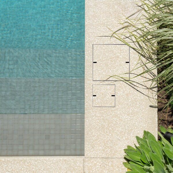 HIDE Concrete Skimmer Cover and Access Cover installed into exposed honed aggregate concrete pool surround.