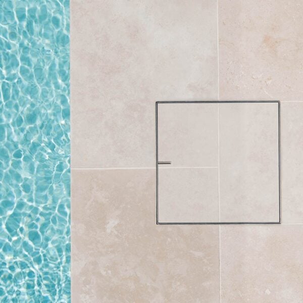 Modern cream tile installed into HIDE Skimmer Cover with grout and tile pattern running through the middle.