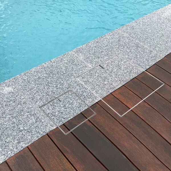 HIDE Skimmer Cover and Access Cover with dual tile and decking inlay next to pool.