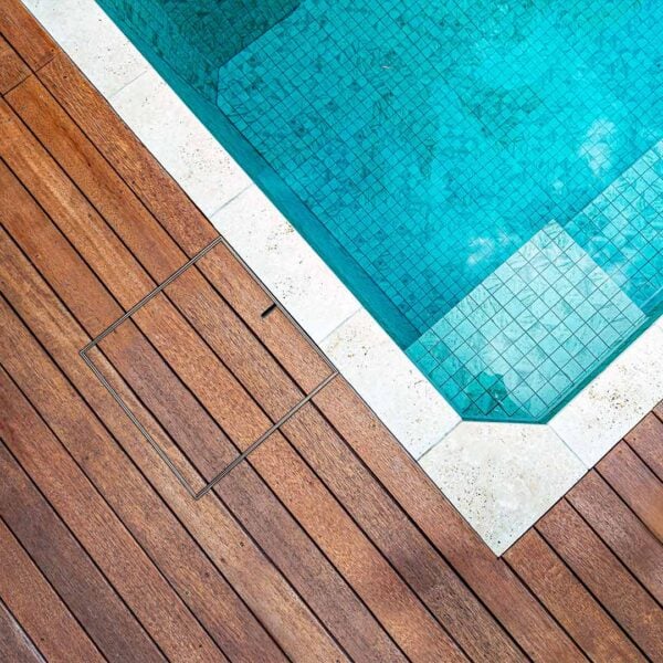 HIDE Skimmer Cover in decking next to pool.
