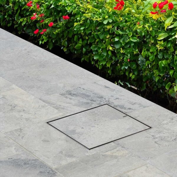 Flush sitting Hidden Drain Cover with grey tile inlay.