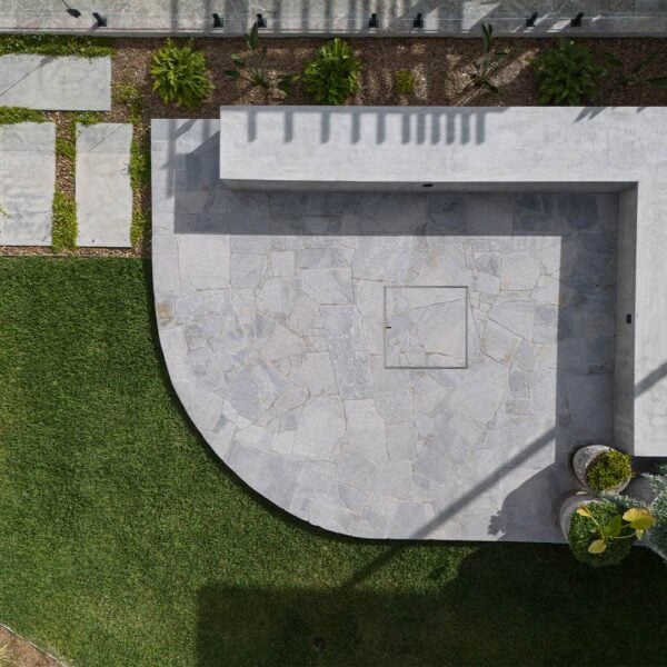 Large HIDE Manhole Cover with crazy pave inlay in sitting area in backyard.